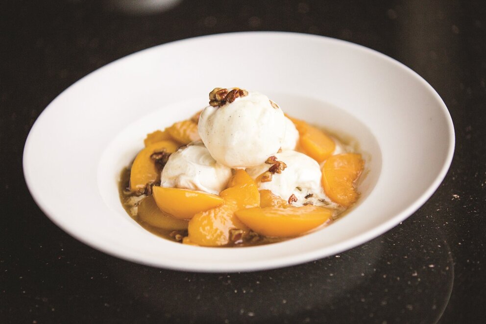 Bowl of peaches with ice cream