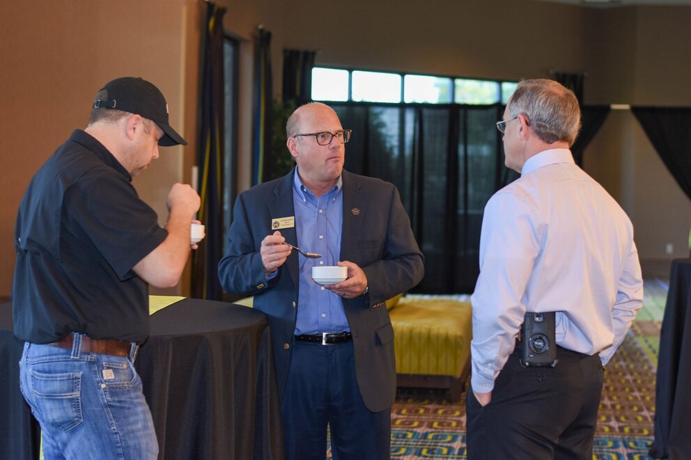 Men talking in a group while eating ice cream at Texarkana Convention Center