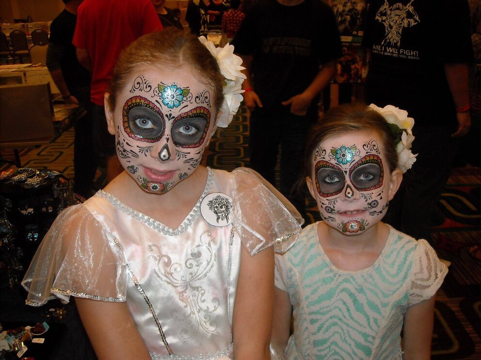 two young girls with day of the dead face paint
